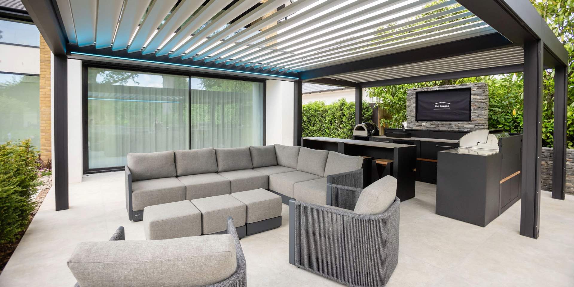 Renson steel pergola with Grillo outdoor kitchen and outdoor TV