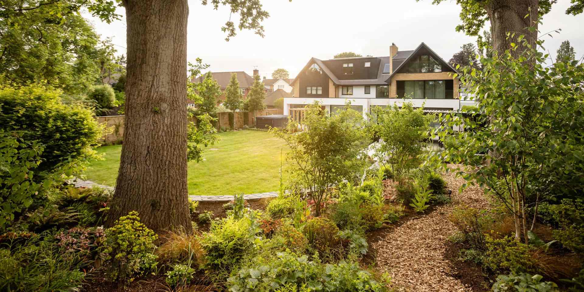 Large country garden in Harpenden, Hertfordshire with lawn, woodland boards and contemporary entertaining area