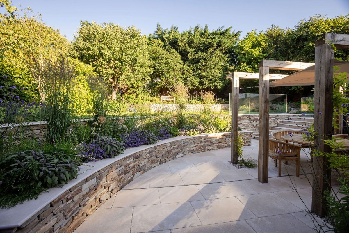 Yellow quartz paddle stone walls with oak arches and beige limestone paving