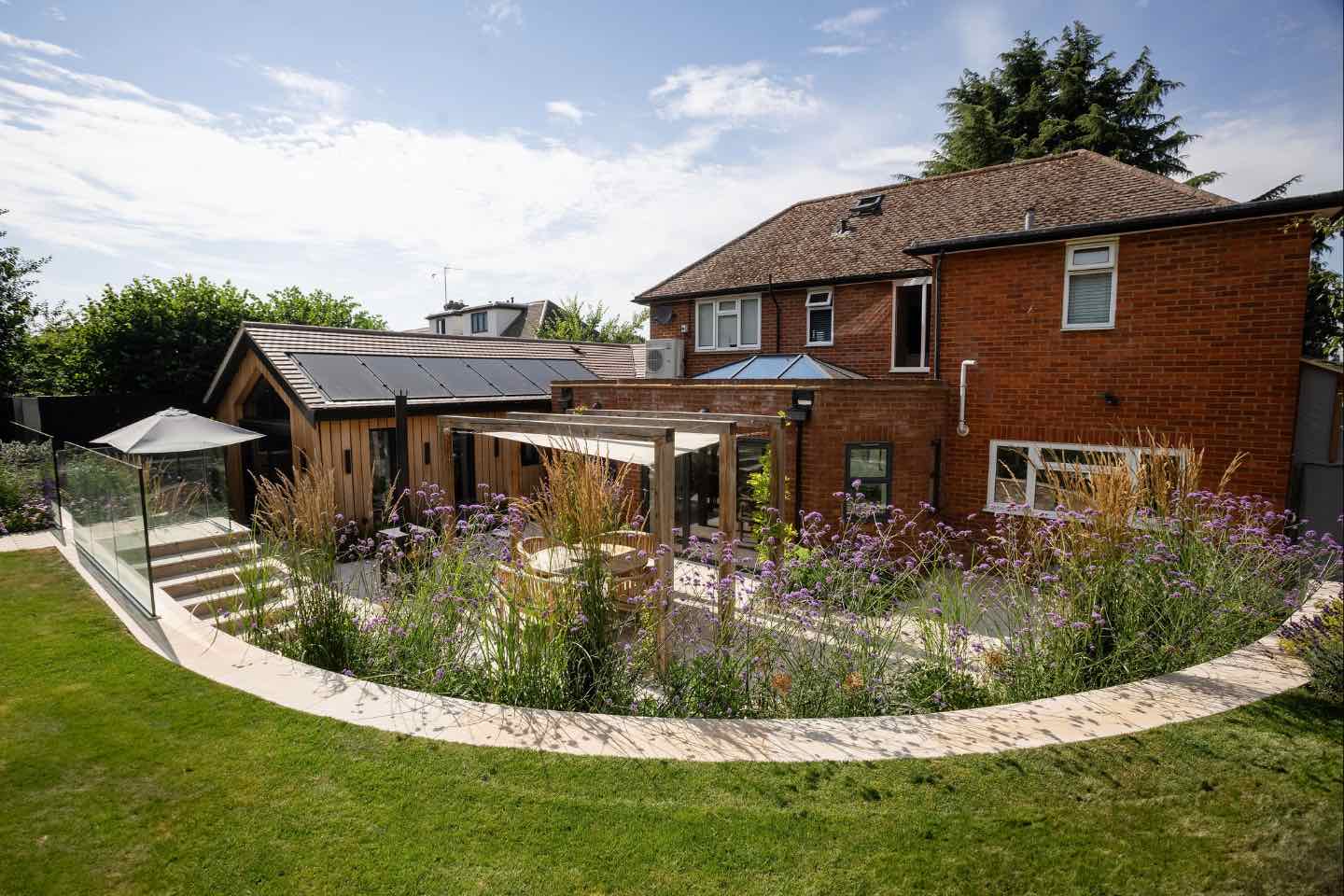 Sweeping curved walled garden in Hertfordshire with steps