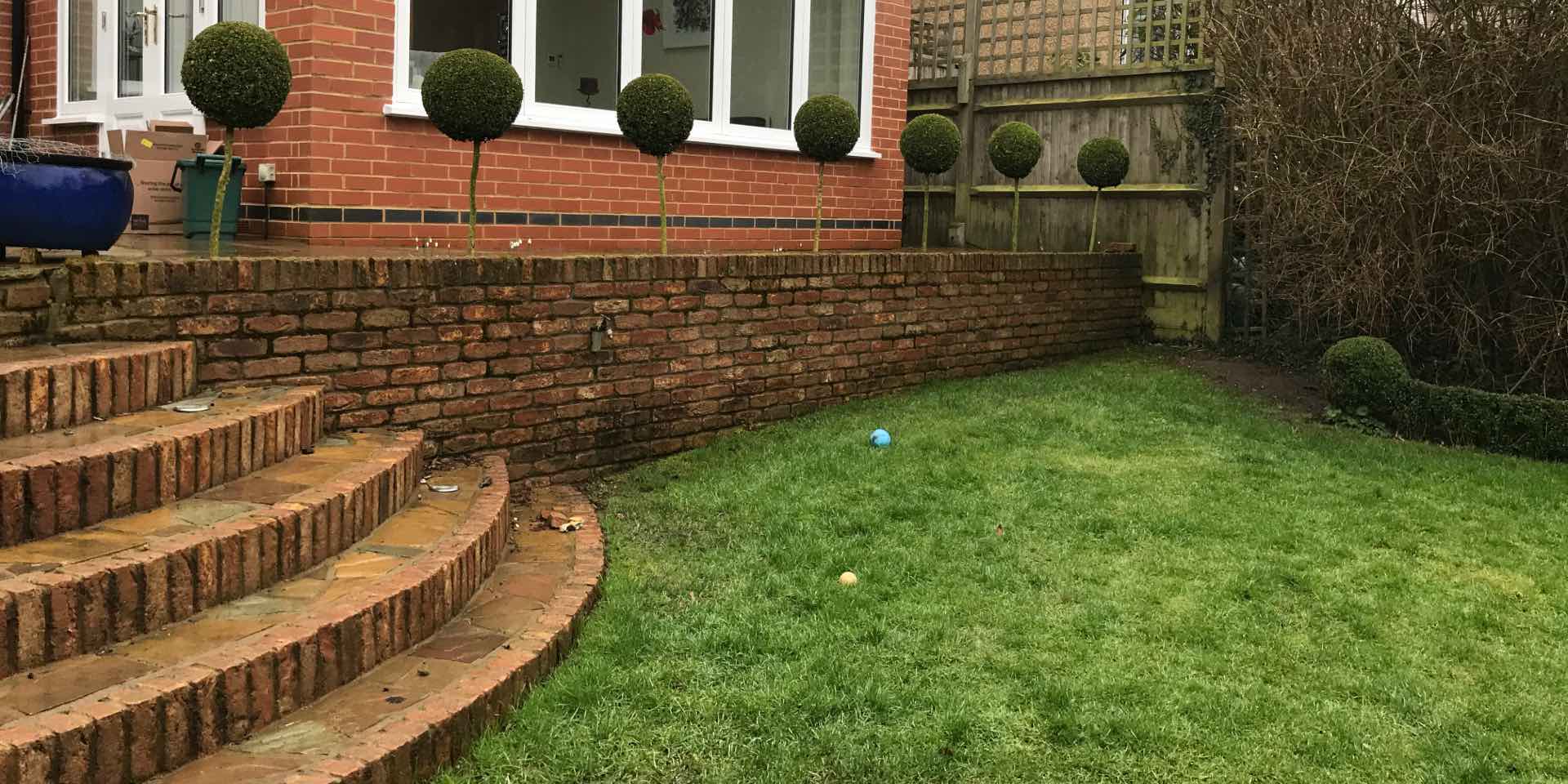 Brick steps and brick planter before landscape re-design