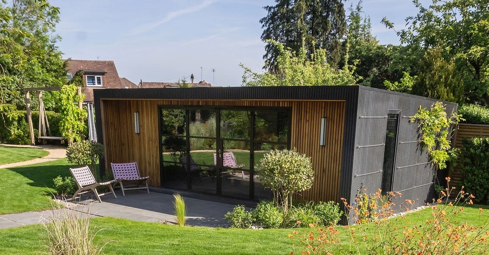 Harpenden Garden and Games Room with granite paving, planting composite cladding and garden room critical doors and windows